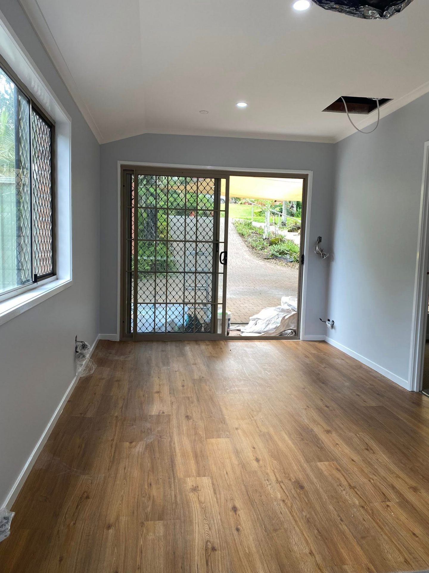 Two-tone grey interior repaint with white ceiling and trim by Munn & Co. Finishes in Tweed Heads